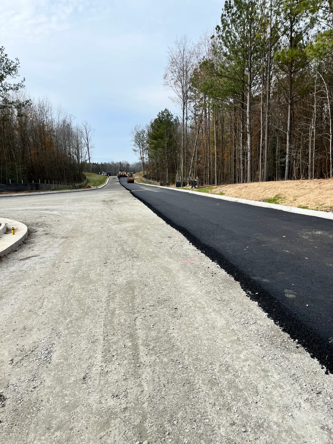 New road build on compacted stone base through pines